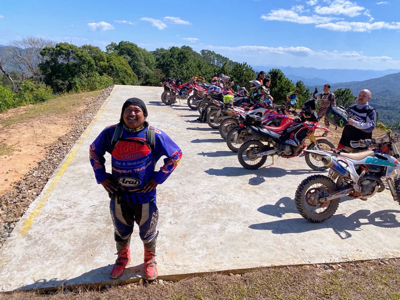Five Honda CRF enduros lined up at a concrete viewpoint along the Helicopter Trail, west of Pai.